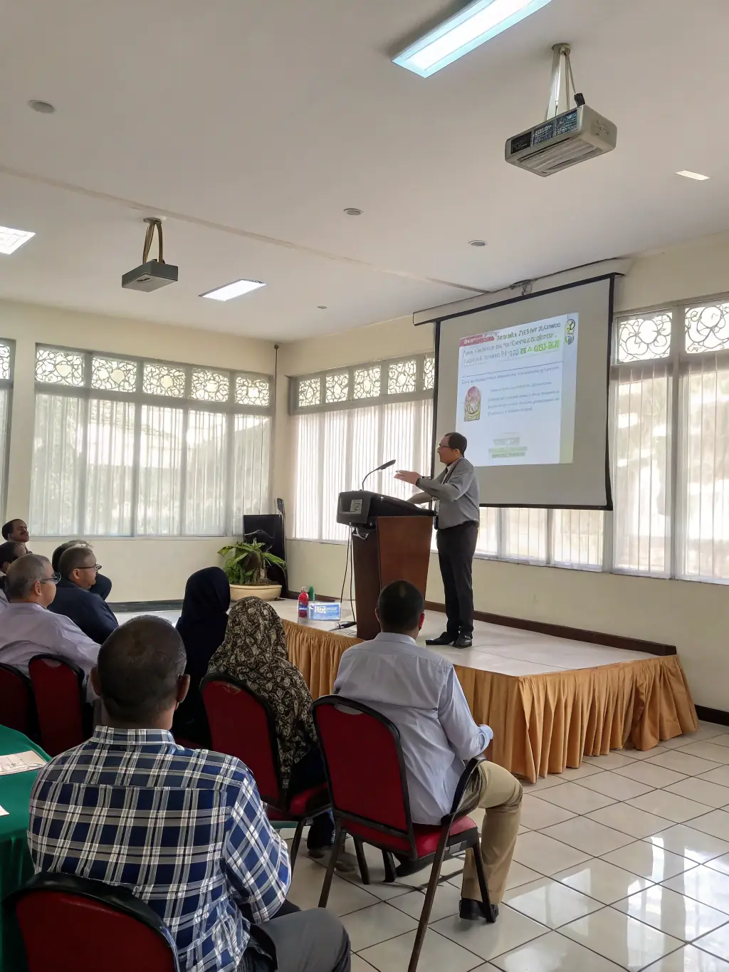 A close-up shot of a speaker presenting at the Renewable Energy Conference 2022 in Manchester, with a slide about solar panel efficiency.